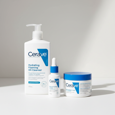 Cerave skincare products including a foaming cleanser, serum, and cream on a light background